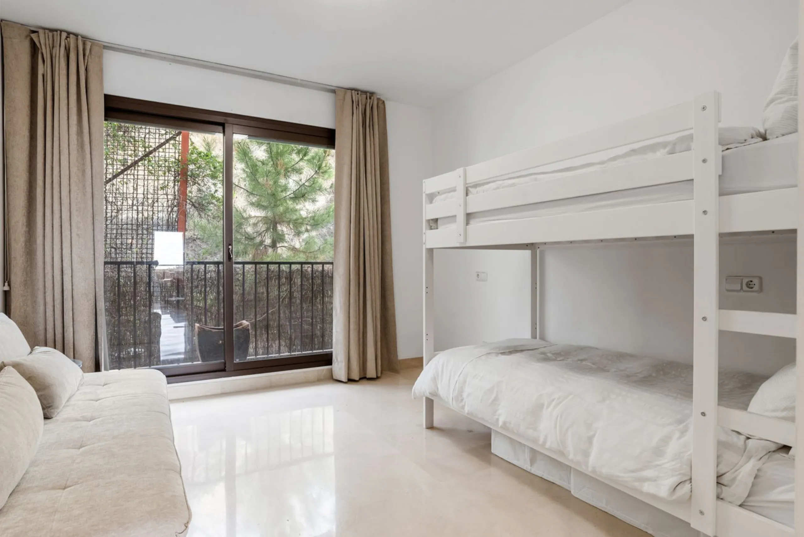 Discover this bright and elegant two bedroom first floor apartment located within the sought after Los Pinos in Los Arqueros Golf and Country Club. Set in a peaceful and secure environment, the property enjoys an elevated position with beautiful open view