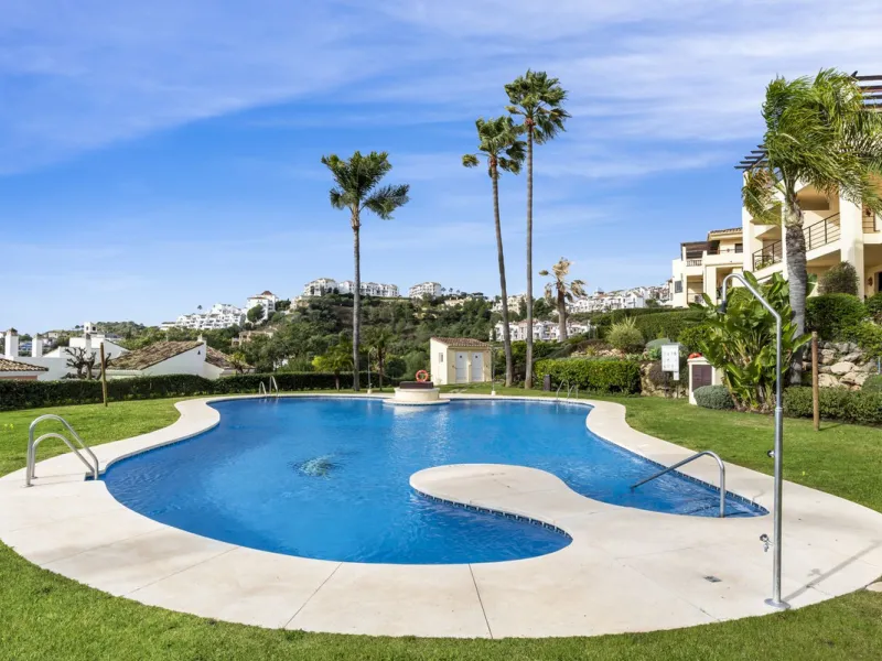Discover this bright and elegant two bedroom first floor apartment located within the sought after Los Pinos in Los Arqueros Golf and Country Club. Set in a peaceful and secure environment, the property enjoys an elevated position with beautiful open view