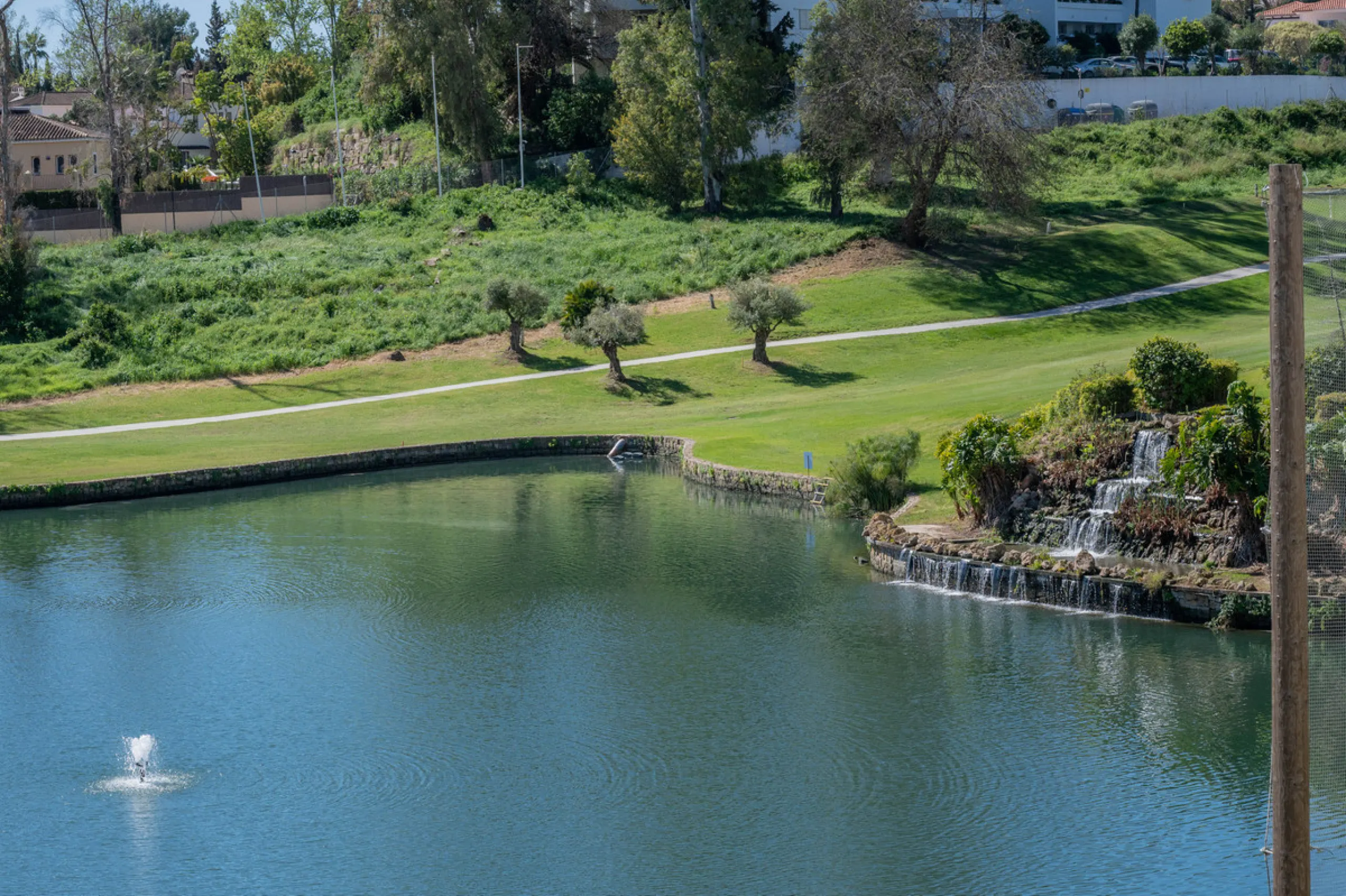 This truly special home combines space, light and tranquility in one of Guadalmina's most sought-after settings. Located on the first floor yet elevated above the golf course, the apartment enjoys the feel of a third floor or penthouse, with uninterrupted