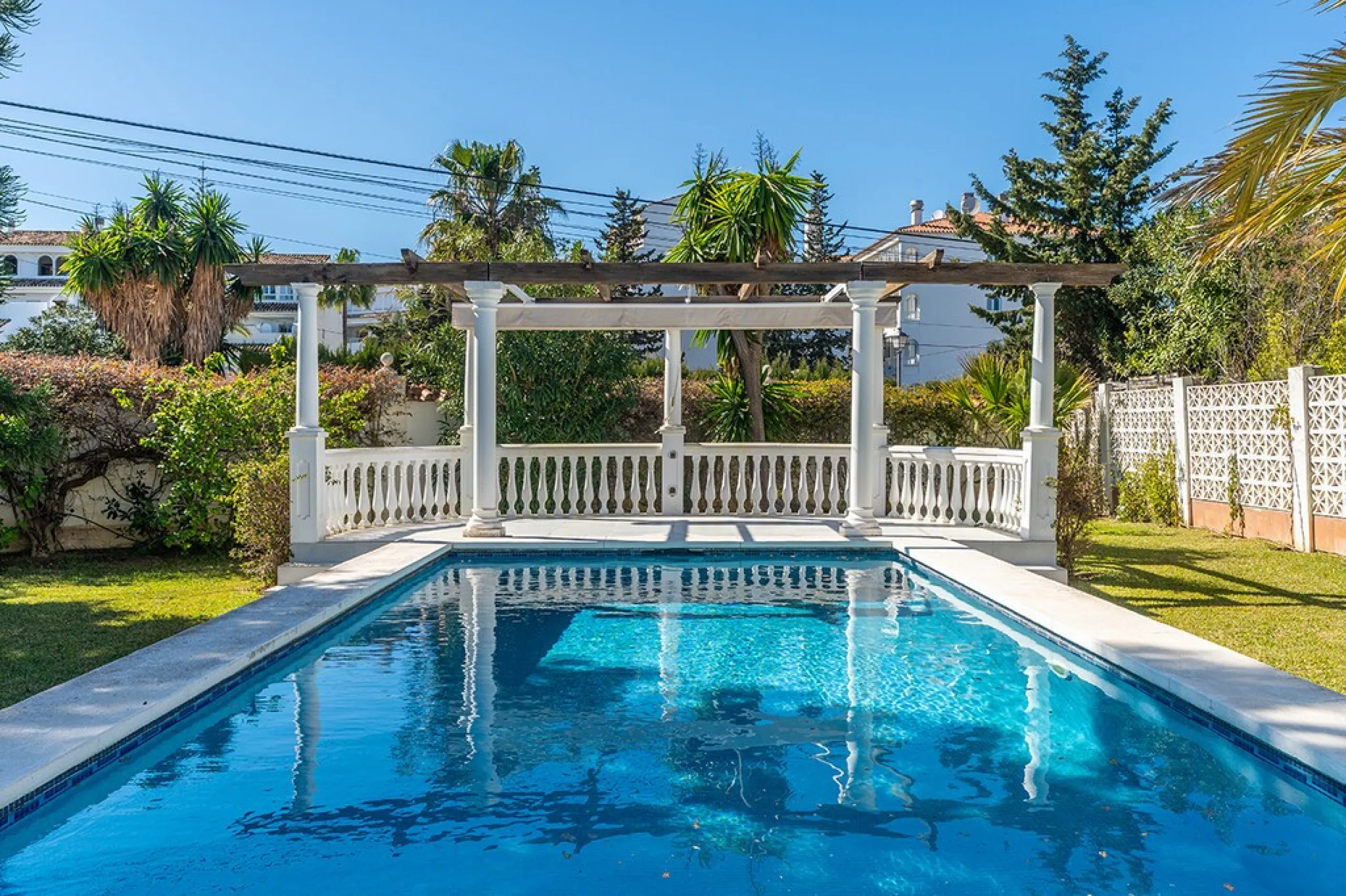 Just 50 metres from the beach, this beautifully renovated and modernised four bedroom, three bathroom villa is set on a spacious, flat plot featuring a large swimming pool and lush mature garden. The property boasts a fully upgraded kitchen and bathrooms,