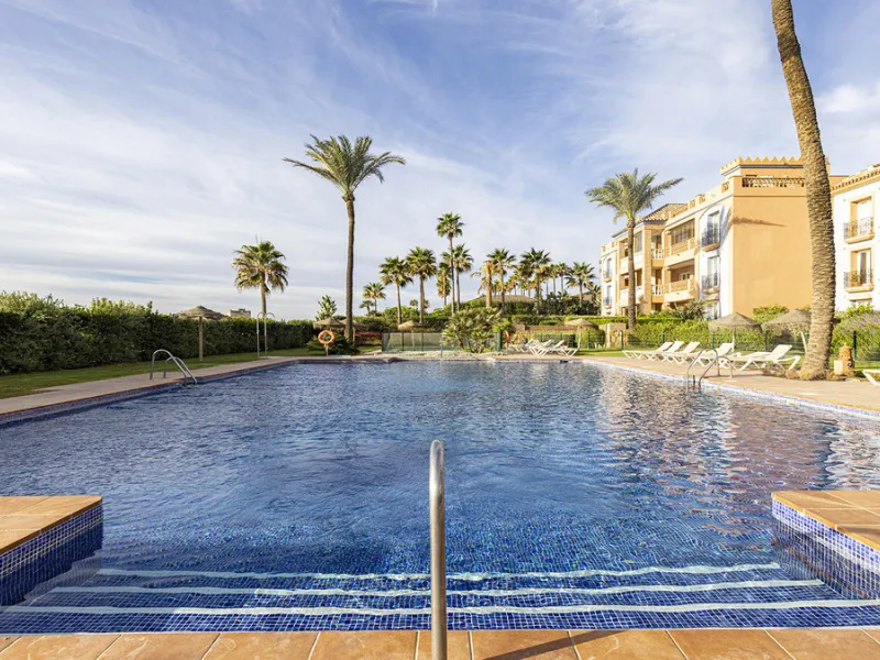 Wake up to breathtaking sea views from this exceptional 3-bedroom, 2-bathroom ground floor apartment set within one of the most prestigious frontline beach urbanisations in Casares Costa. With a spacious terrace overlooking beautifully landscaped gardens 