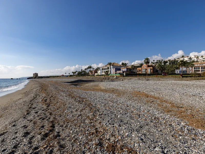 Wake up to breathtaking sea views from this exceptional 3-bedroom, 2-bathroom ground floor apartment set within one of the most prestigious frontline beach urbanisations in Casares Costa. With a spacious terrace overlooking beautifully landscaped gardens 