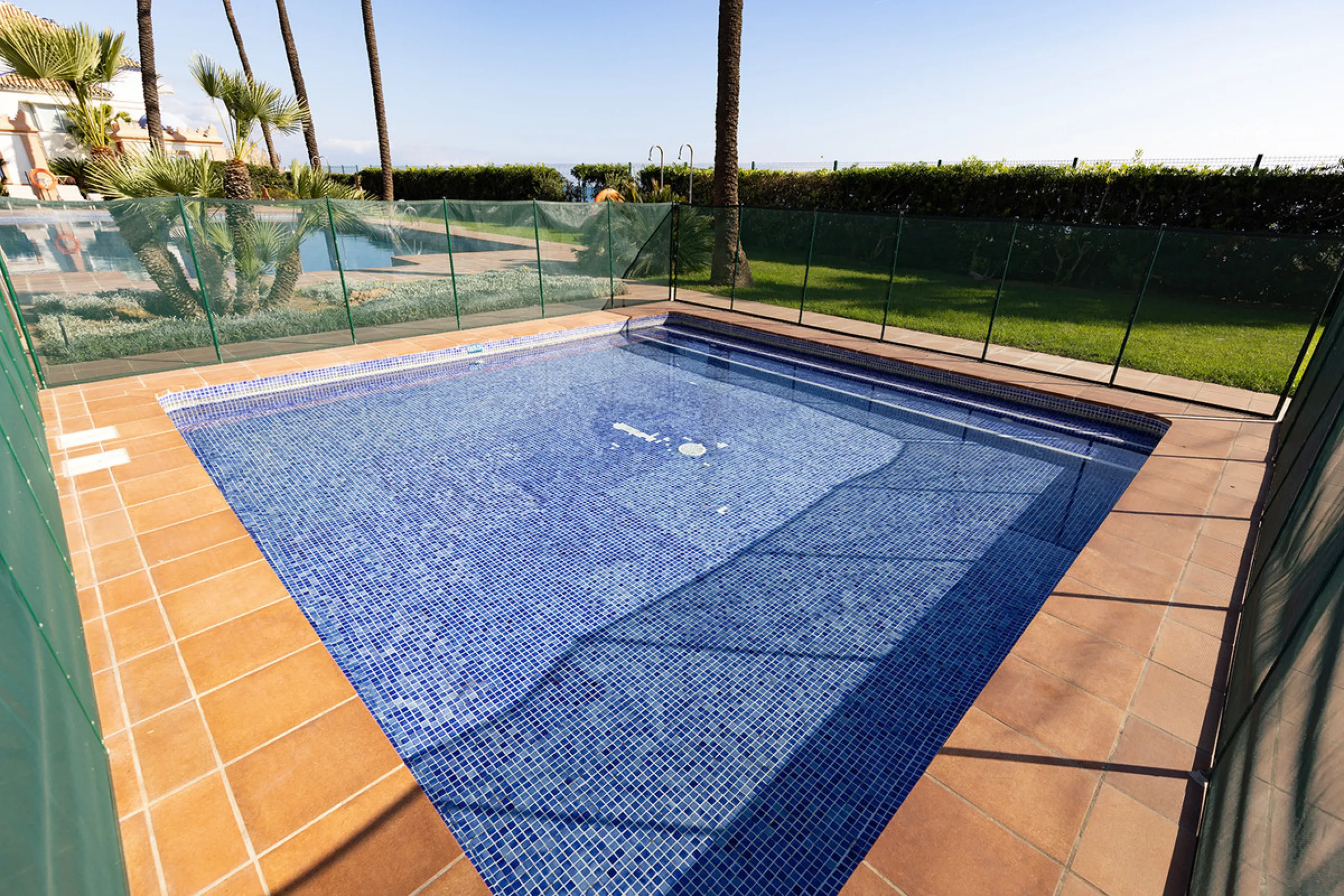 Wake up to breathtaking sea views from this exceptional 3-bedroom, 2-bathroom ground floor apartment set within one of the most prestigious frontline beach urbanisations in Casares Costa. With a spacious terrace overlooking beautifully landscaped gardens 