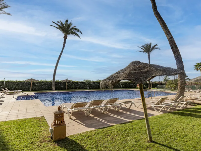 Wake up to breathtaking sea views from this exceptional 3-bedroom, 2-bathroom ground floor apartment set within one of the most prestigious frontline beach urbanisations in Casares Costa. With a spacious terrace overlooking beautifully landscaped gardens 