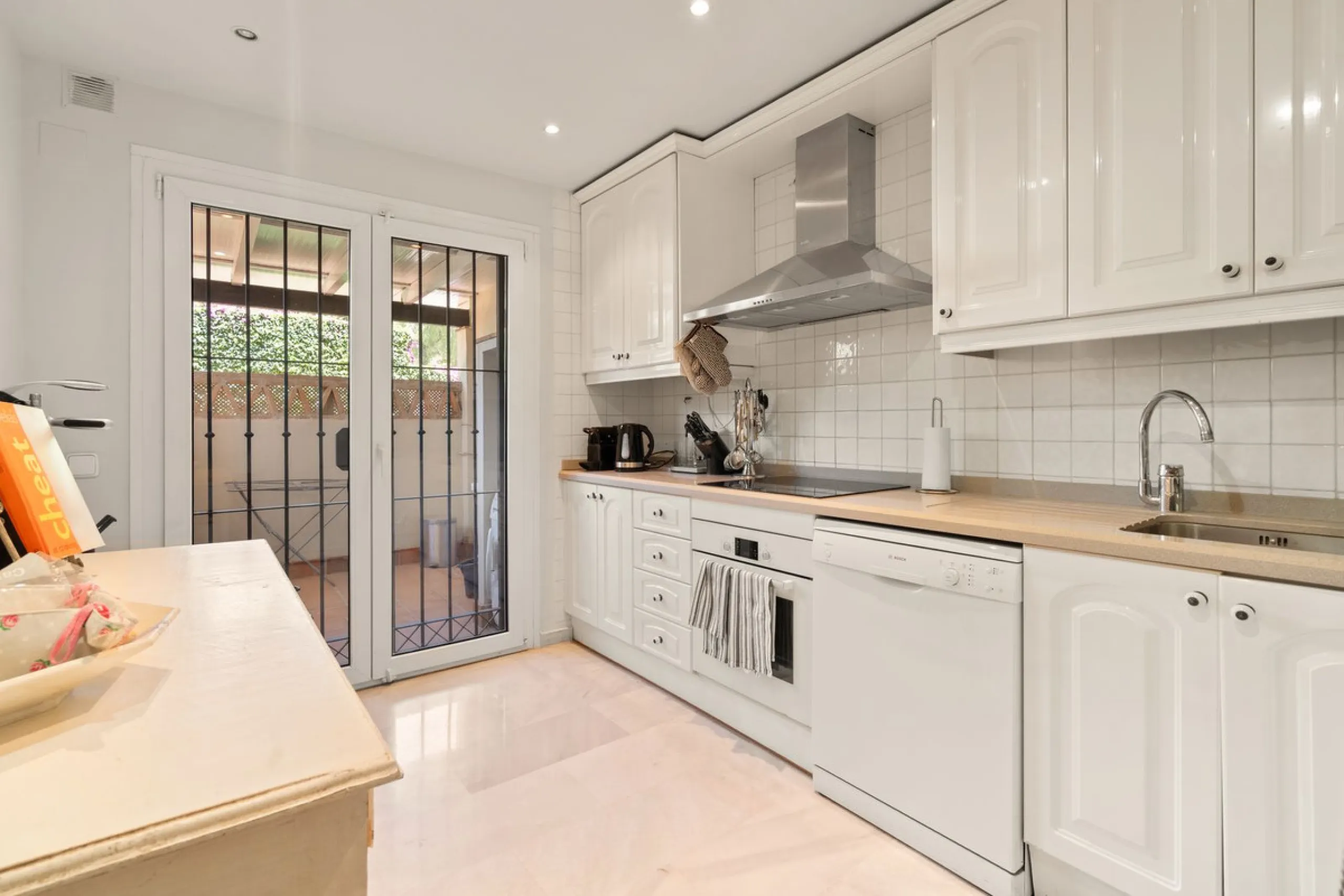 Superb spacious townhouse located in one of the most sought after urbanisations in Guadalmina Baja. Set in sumptuous landscaped gardens with a generous sized swimming pool. The property is on two storeys with a large storage in the basement and double gar