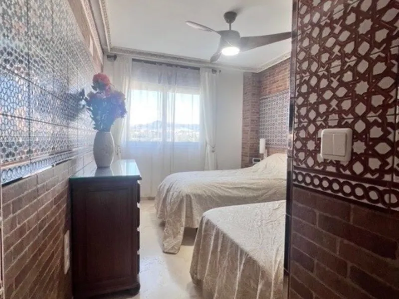 This charming top-floor apartment, located in the sought-after Guadalmina Baja, offers a comfortable and modern living experience. The apartment features two spacious bedrooms and two renovated bathrooms. The open-concept layout creates a seamless flow be