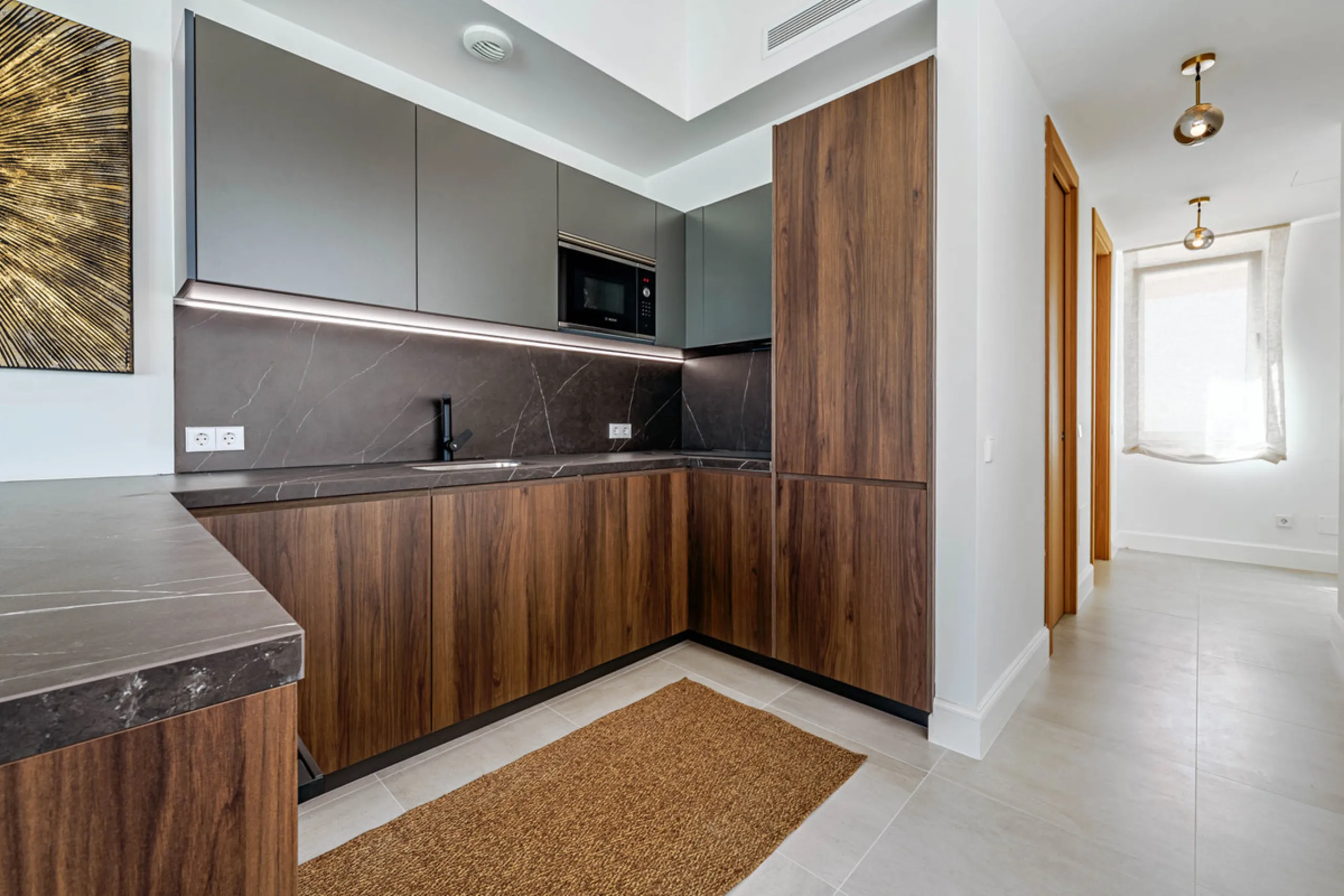 This stunning penthouse is located in a charming four-storey building constructed in 2021, right in the heart of Malaga's Historic Centre. With 122 m² of built area and two terraces totaling 52 m², the property boasts a sleek contemporary design and high-