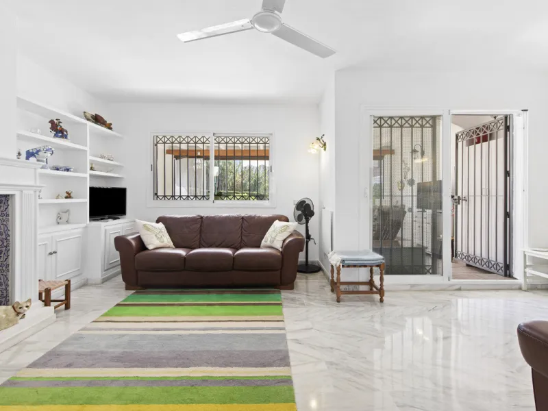 This charming two-level property offers spacious and versatile accommodation, finished to a high standard and filled with natural light throughout. The large living room is a welcoming focal point, featuring marble flooring, a beamed ceiling, a wood-burni