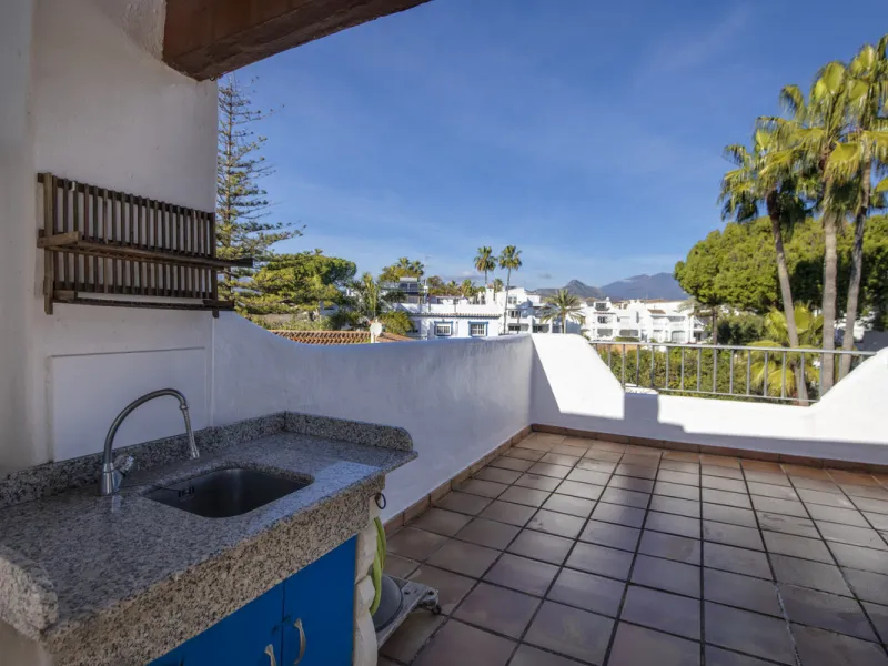 This charming two-level property offers spacious and versatile accommodation, finished to a high standard and filled with natural light throughout. The large living room is a welcoming focal point, featuring marble flooring, a beamed ceiling, a wood-burni