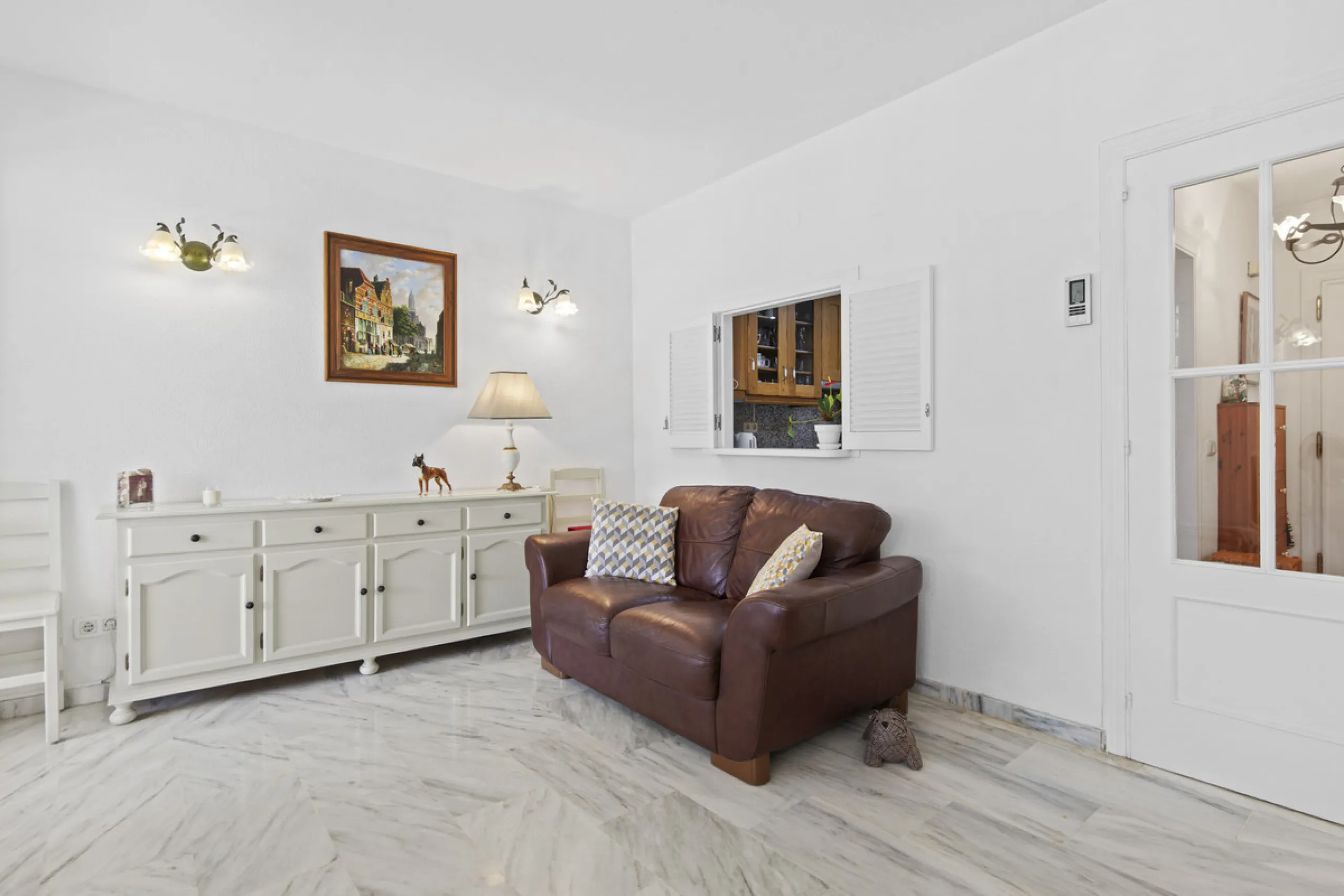 This charming two-level property offers spacious and versatile accommodation, finished to a high standard and filled with natural light throughout. The large living room is a welcoming focal point, featuring marble flooring, a beamed ceiling, a wood-burni