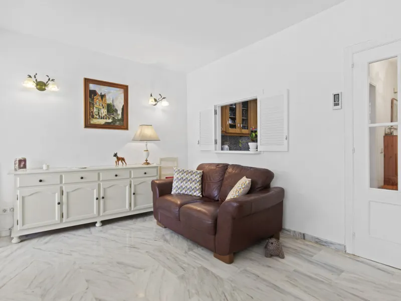 This charming two-level property offers spacious and versatile accommodation, finished to a high standard and filled with natural light throughout. The large living room is a welcoming focal point, featuring marble flooring, a beamed ceiling, a wood-burni