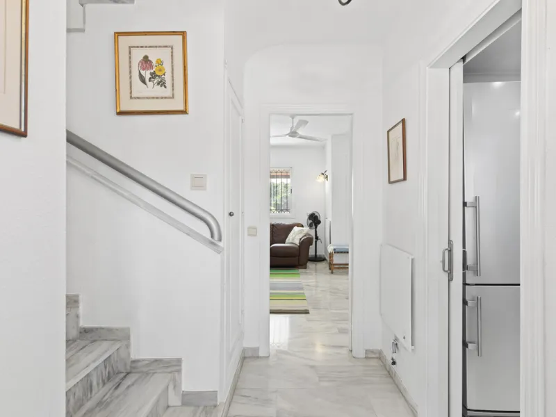 This charming two-level property offers spacious and versatile accommodation, finished to a high standard and filled with natural light throughout. The large living room is a welcoming focal point, featuring marble flooring, a beamed ceiling, a wood-burni