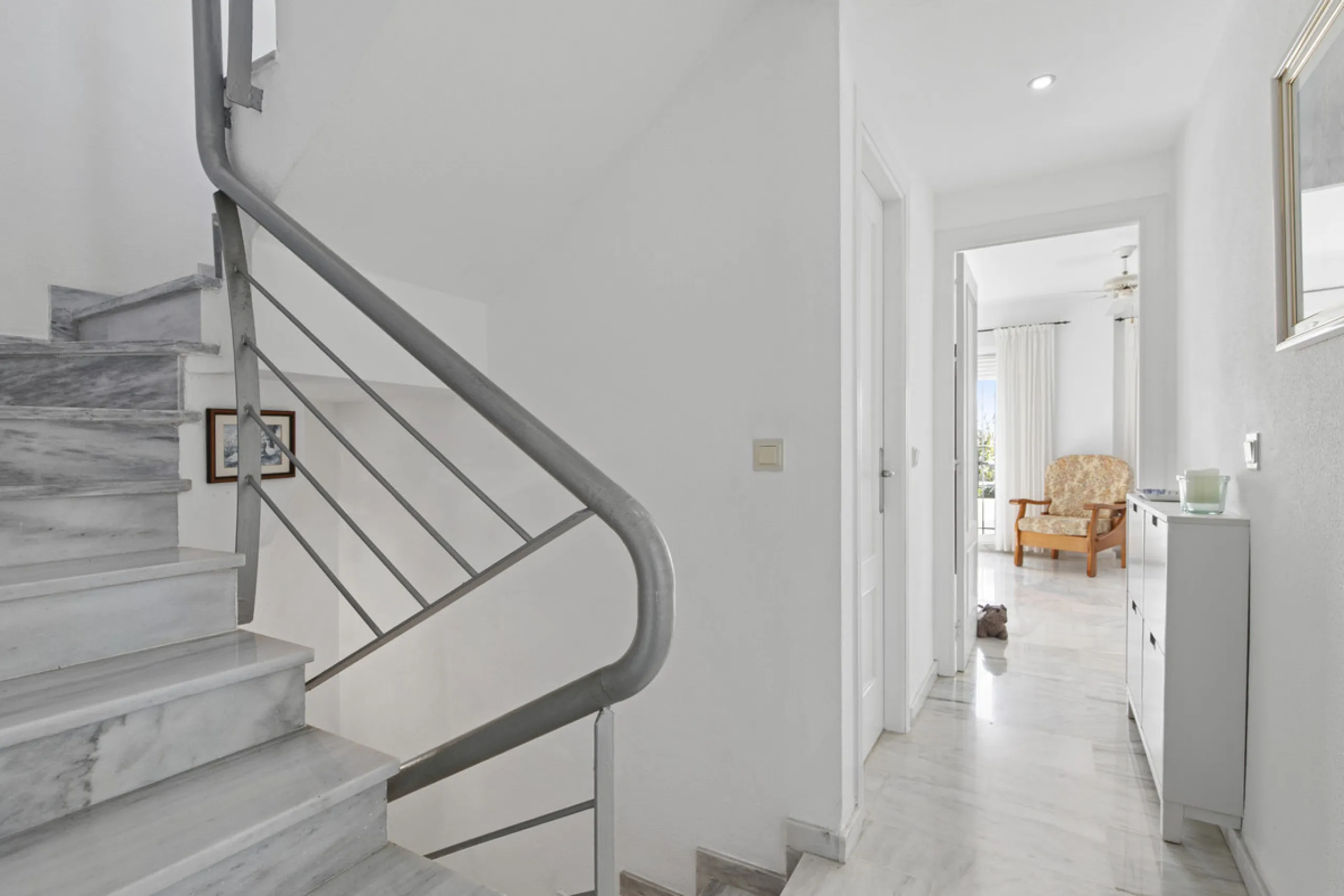 This charming two-level property offers spacious and versatile accommodation, finished to a high standard and filled with natural light throughout. The large living room is a welcoming focal point, featuring marble flooring, a beamed ceiling, a wood-burni