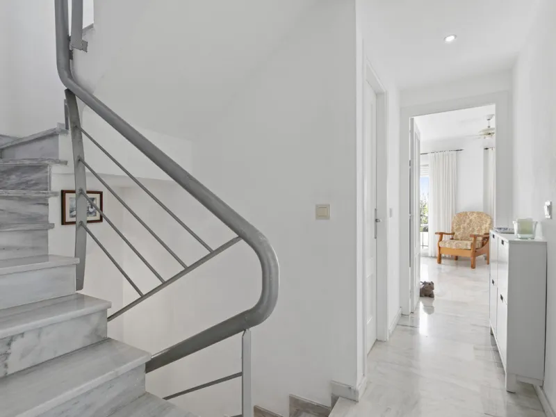 This charming two-level property offers spacious and versatile accommodation, finished to a high standard and filled with natural light throughout. The large living room is a welcoming focal point, featuring marble flooring, a beamed ceiling, a wood-burni