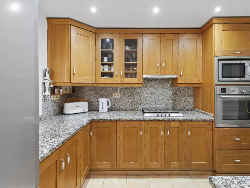 This charming two-level property offers spacious and versatile accommodation, finished to a high standard and filled with natural light throughout. The large living room is a welcoming focal point, featuring marble flooring, a beamed ceiling, a wood-burni