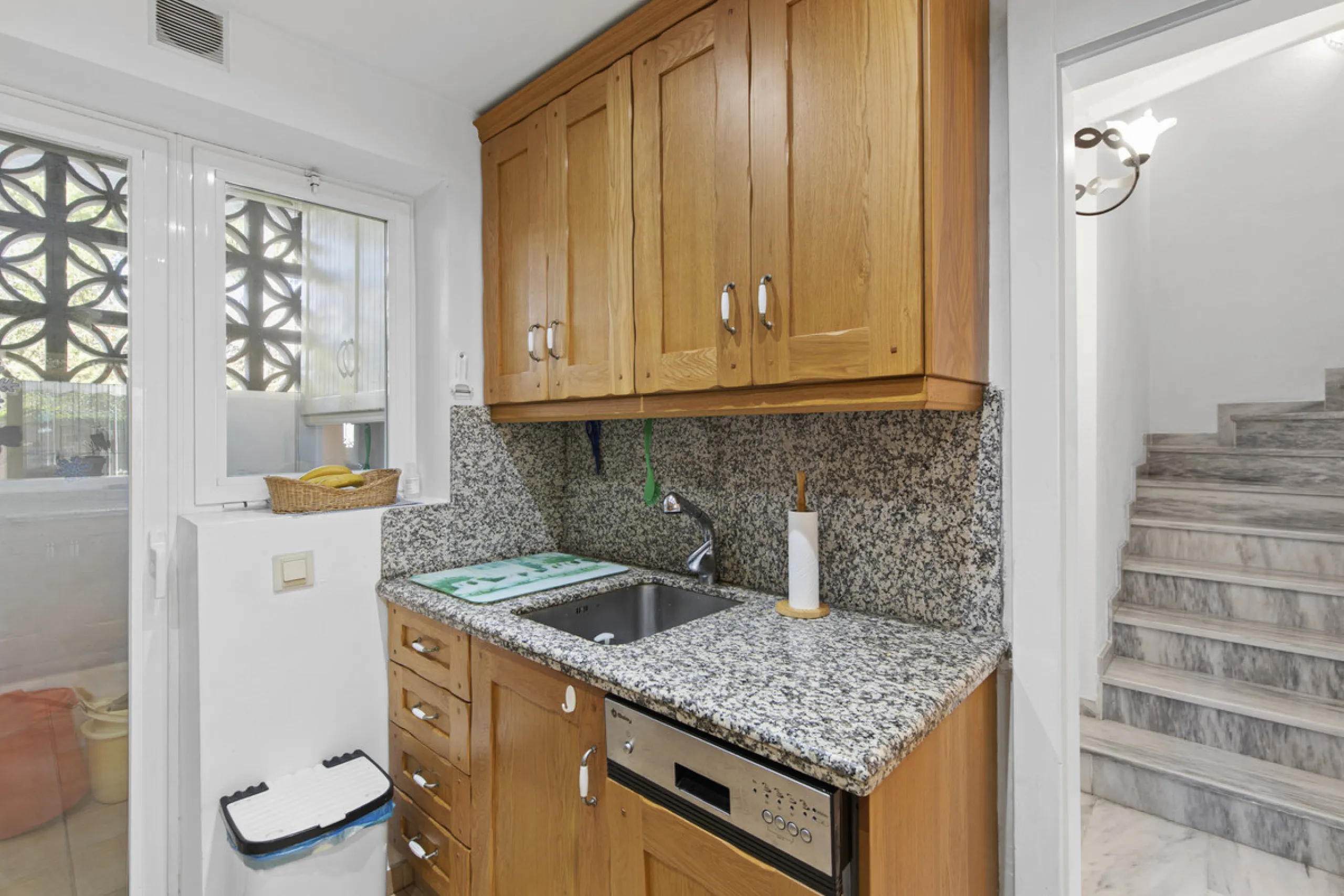 This charming two-level property offers spacious and versatile accommodation, finished to a high standard and filled with natural light throughout. The large living room is a welcoming focal point, featuring marble flooring, a beamed ceiling, a wood-burni