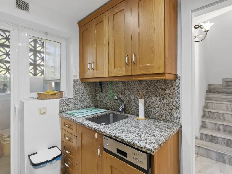 This charming two-level property offers spacious and versatile accommodation, finished to a high standard and filled with natural light throughout. The large living room is a welcoming focal point, featuring marble flooring, a beamed ceiling, a wood-burni