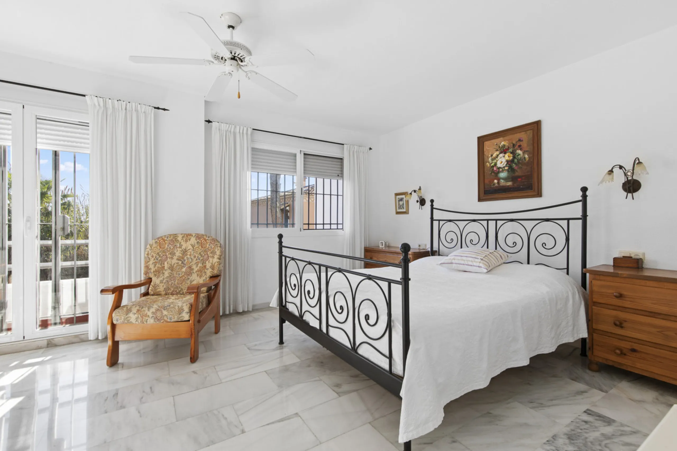 This charming two-level property offers spacious and versatile accommodation, finished to a high standard and filled with natural light throughout. The large living room is a welcoming focal point, featuring marble flooring, a beamed ceiling, a wood-burni