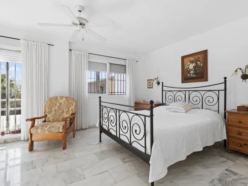 This charming two-level property offers spacious and versatile accommodation, finished to a high standard and filled with natural light throughout. The large living room is a welcoming focal point, featuring marble flooring, a beamed ceiling, a wood-burni
