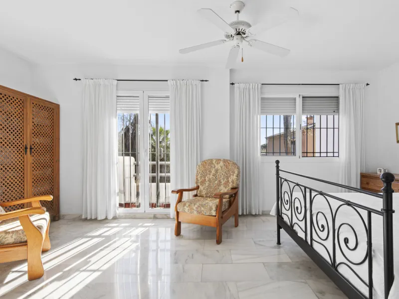 This charming two-level property offers spacious and versatile accommodation, finished to a high standard and filled with natural light throughout. The large living room is a welcoming focal point, featuring marble flooring, a beamed ceiling, a wood-burni