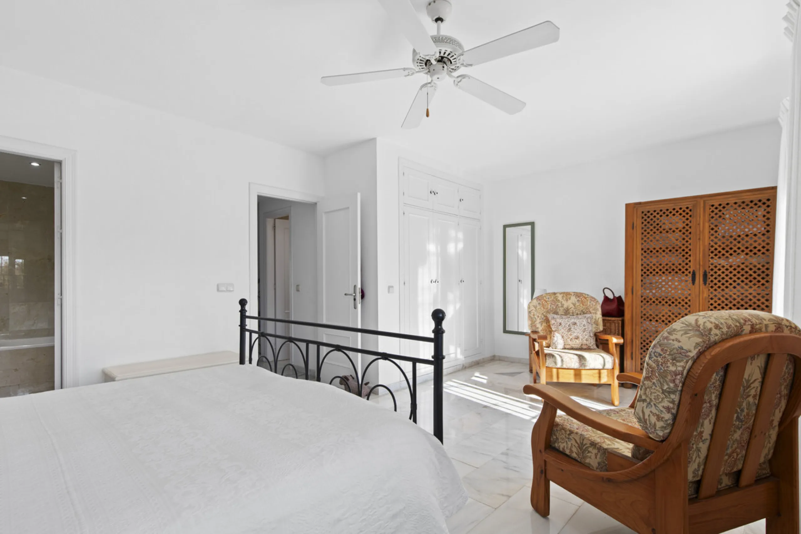 This charming two-level property offers spacious and versatile accommodation, finished to a high standard and filled with natural light throughout. The large living room is a welcoming focal point, featuring marble flooring, a beamed ceiling, a wood-burni
