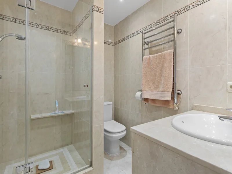 This charming two-level property offers spacious and versatile accommodation, finished to a high standard and filled with natural light throughout. The large living room is a welcoming focal point, featuring marble flooring, a beamed ceiling, a wood-burni