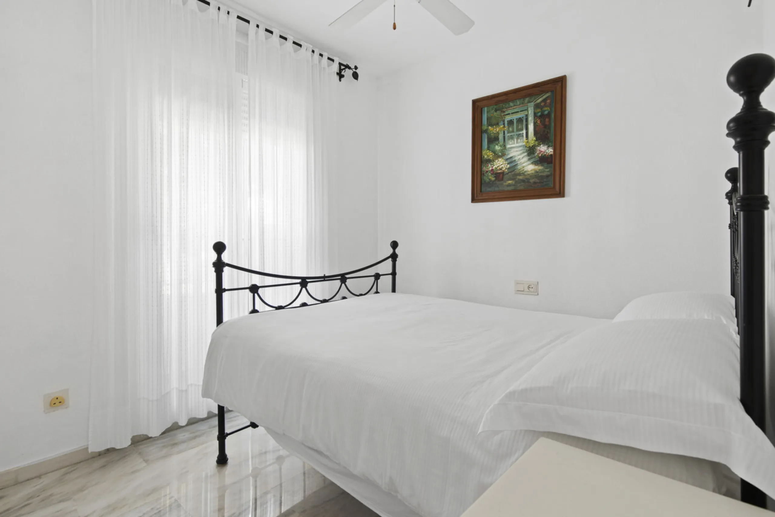This charming two-level property offers spacious and versatile accommodation, finished to a high standard and filled with natural light throughout. The large living room is a welcoming focal point, featuring marble flooring, a beamed ceiling, a wood-burni