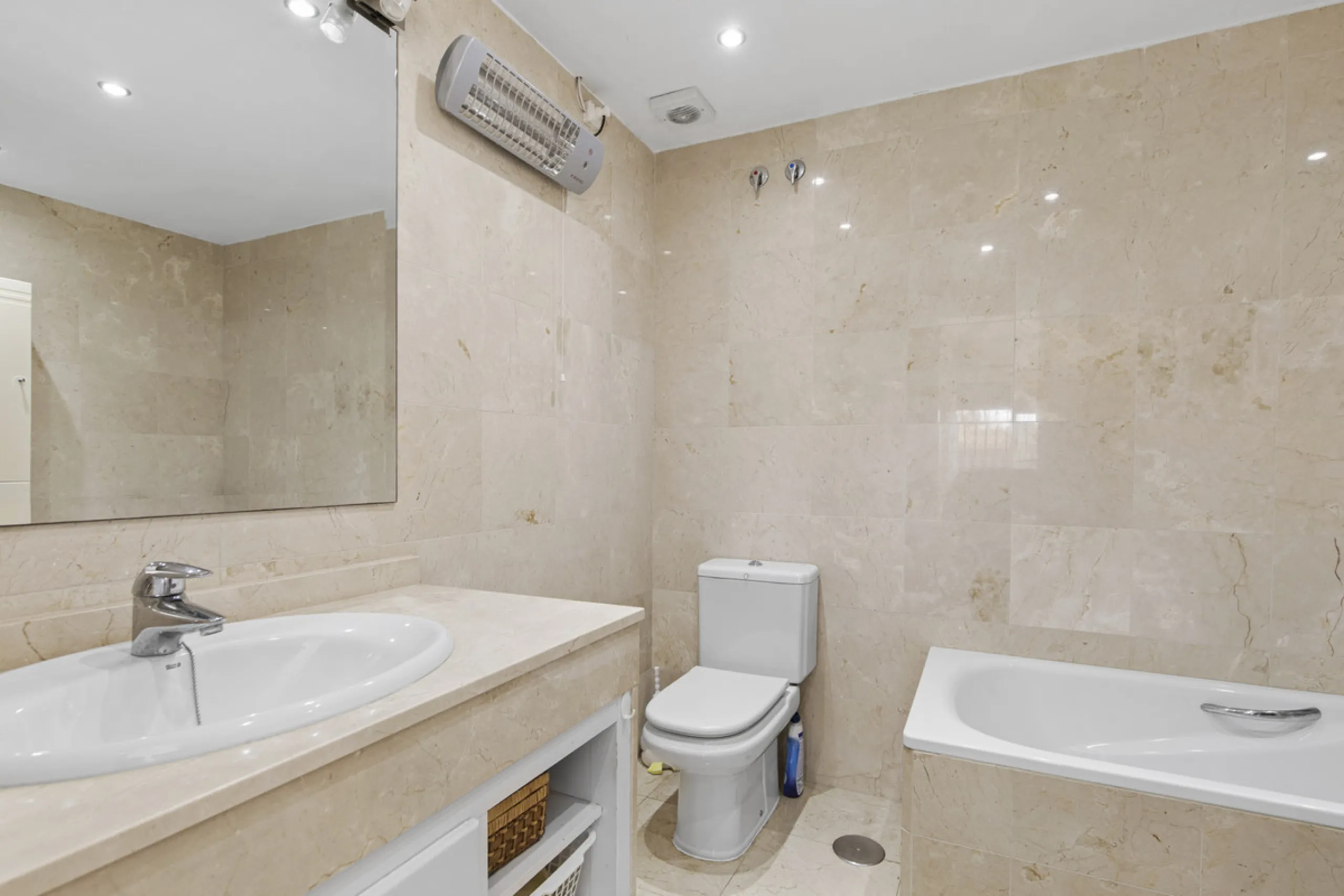 This charming two-level property offers spacious and versatile accommodation, finished to a high standard and filled with natural light throughout. The large living room is a welcoming focal point, featuring marble flooring, a beamed ceiling, a wood-burni