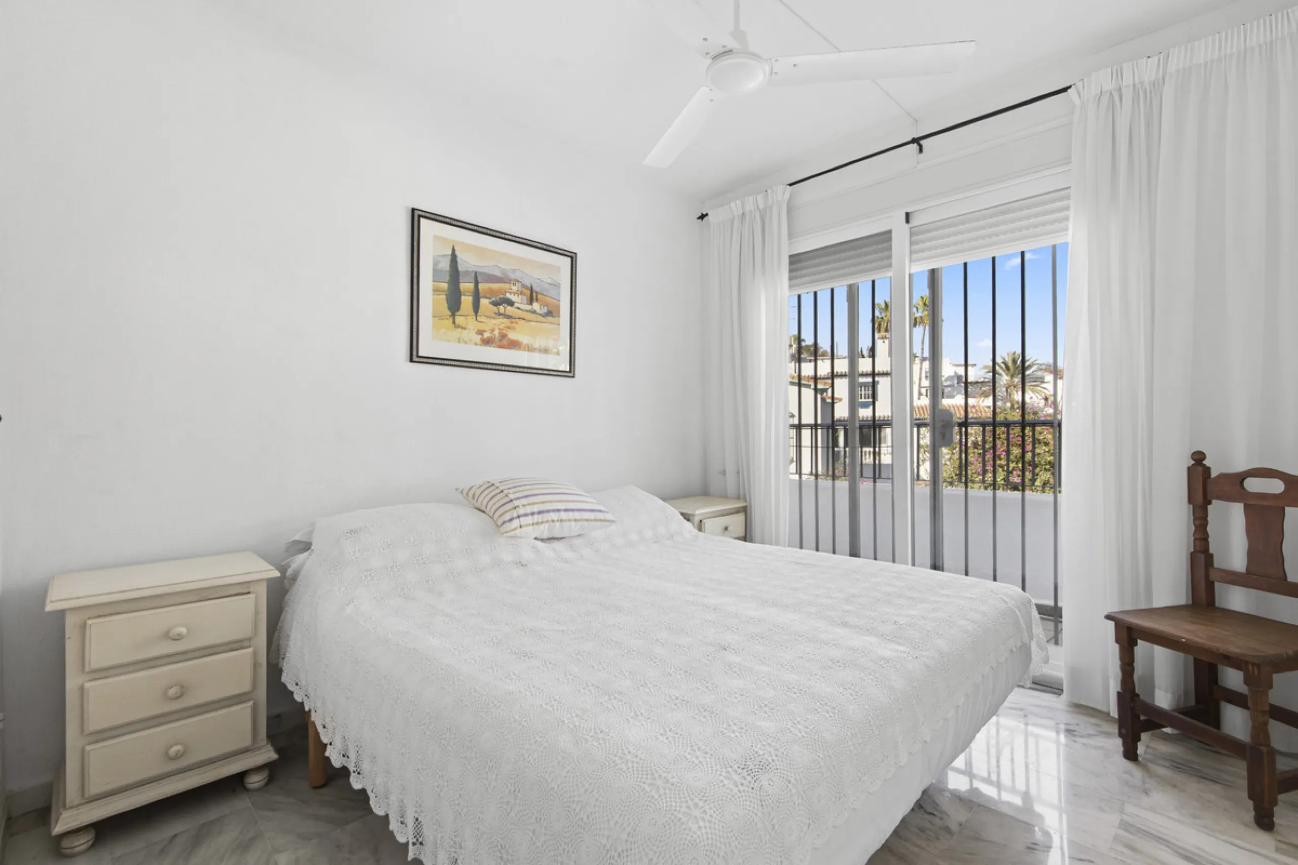 This charming two-level property offers spacious and versatile accommodation, finished to a high standard and filled with natural light throughout. The large living room is a welcoming focal point, featuring marble flooring, a beamed ceiling, a wood-burni