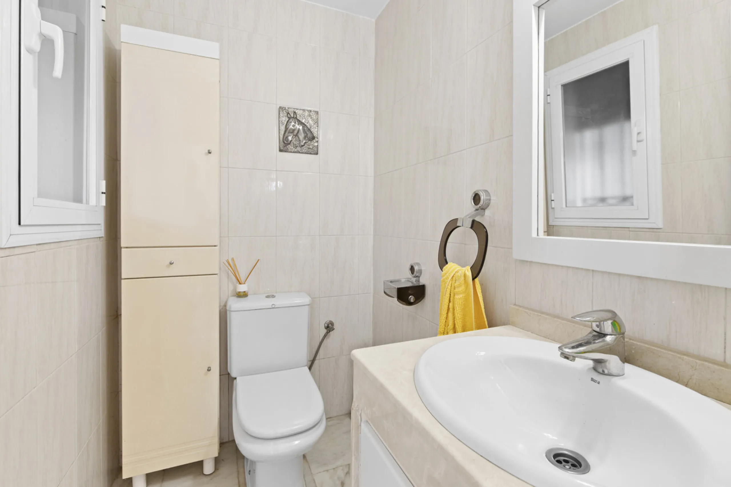 This charming two-level property offers spacious and versatile accommodation, finished to a high standard and filled with natural light throughout. The large living room is a welcoming focal point, featuring marble flooring, a beamed ceiling, a wood-burni