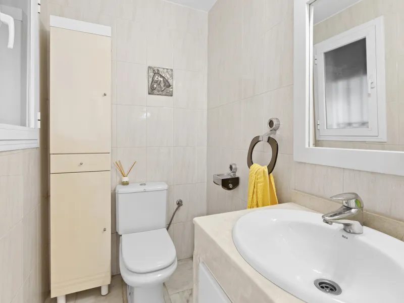This charming two-level property offers spacious and versatile accommodation, finished to a high standard and filled with natural light throughout. The large living room is a welcoming focal point, featuring marble flooring, a beamed ceiling, a wood-burni