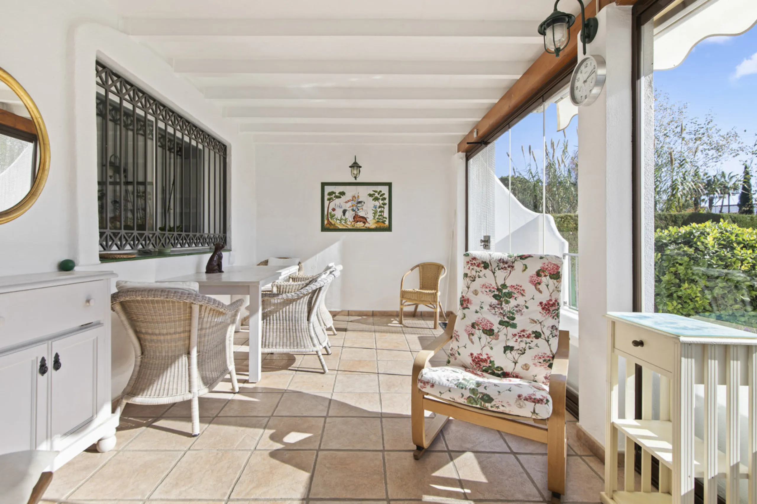 This charming two-level property offers spacious and versatile accommodation, finished to a high standard and filled with natural light throughout. The large living room is a welcoming focal point, featuring marble flooring, a beamed ceiling, a wood-burni