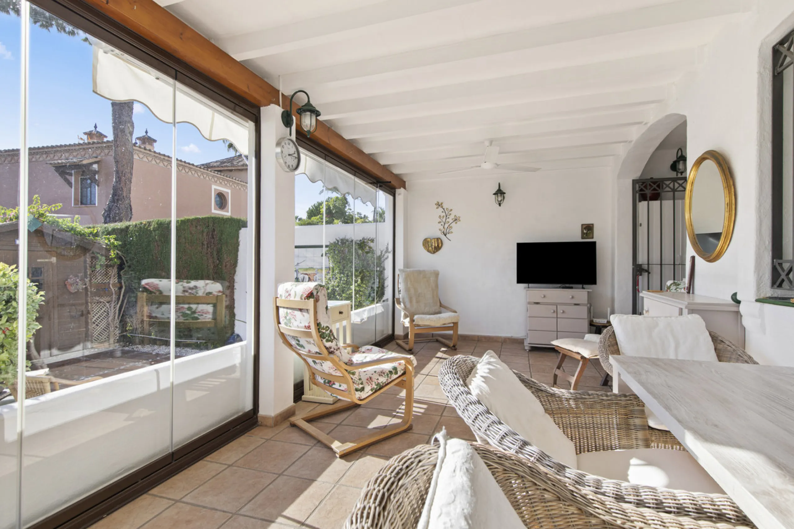 This charming two-level property offers spacious and versatile accommodation, finished to a high standard and filled with natural light throughout. The large living room is a welcoming focal point, featuring marble flooring, a beamed ceiling, a wood-burni