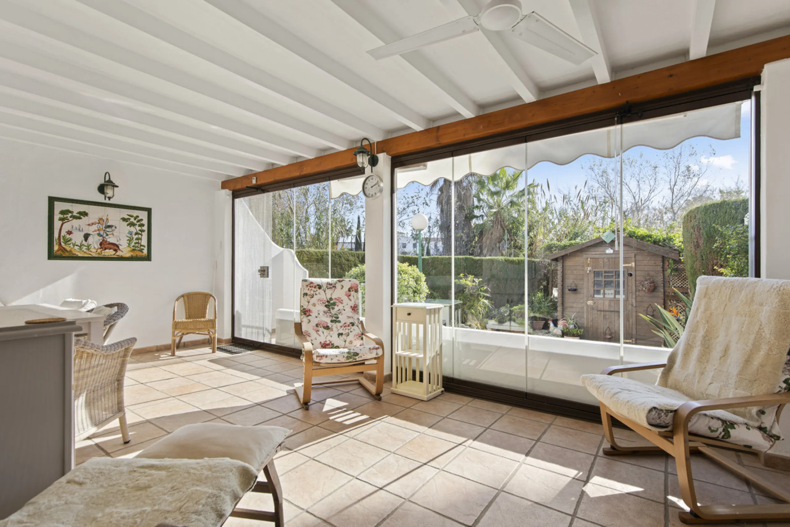 This charming two-level property offers spacious and versatile accommodation, finished to a high standard and filled with natural light throughout. The large living room is a welcoming focal point, featuring marble flooring, a beamed ceiling, a wood-burni