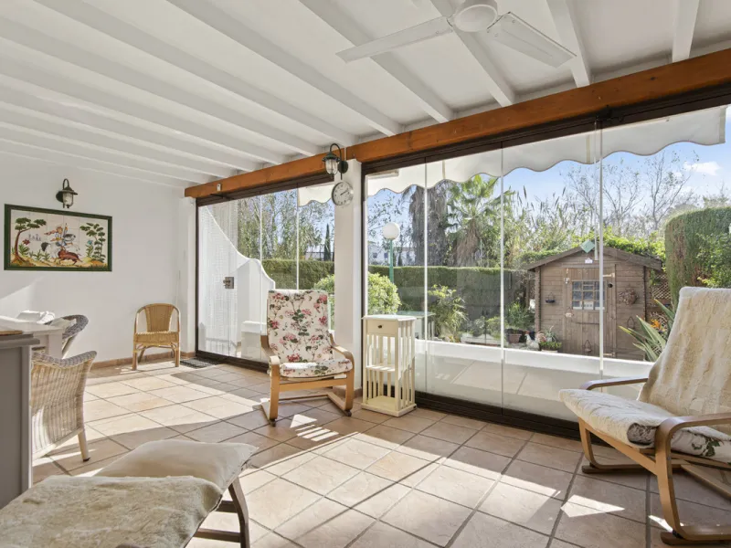 This charming two-level property offers spacious and versatile accommodation, finished to a high standard and filled with natural light throughout. The large living room is a welcoming focal point, featuring marble flooring, a beamed ceiling, a wood-burni