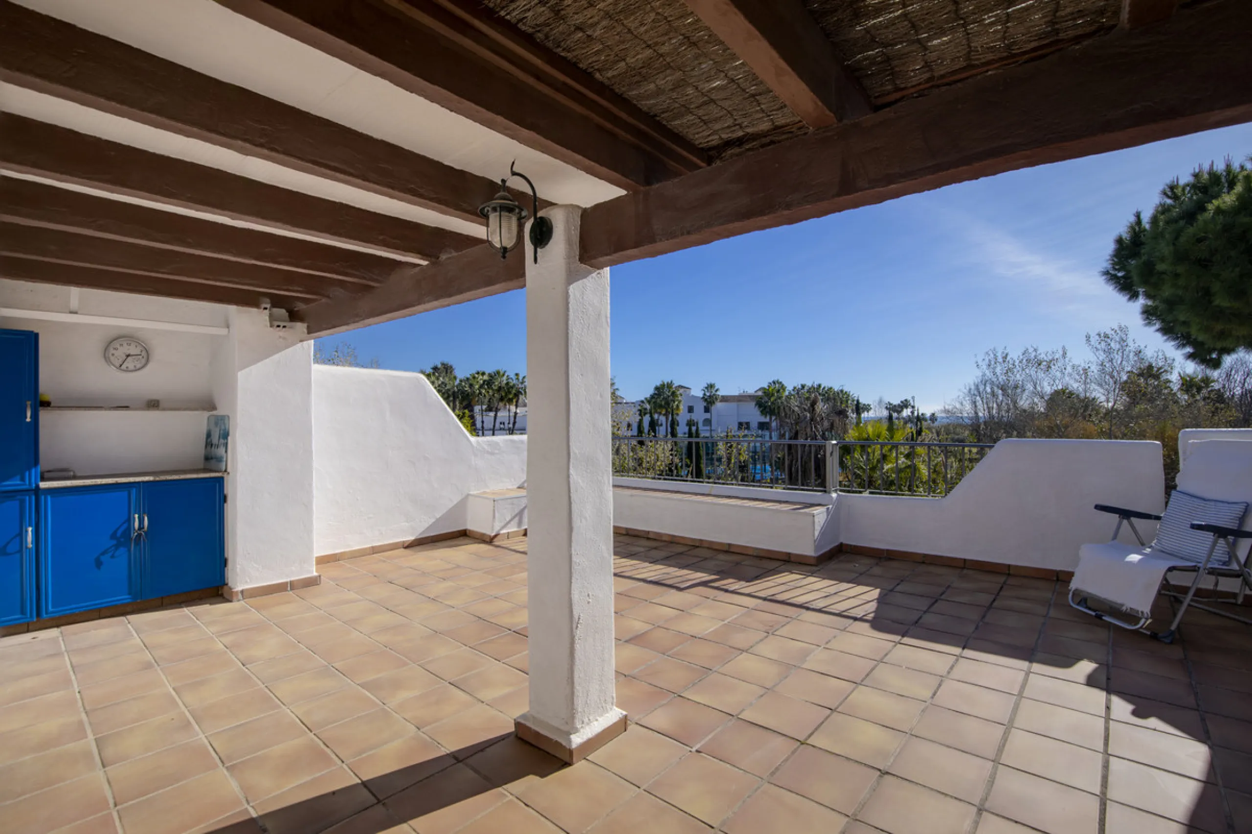 This charming two-level property offers spacious and versatile accommodation, finished to a high standard and filled with natural light throughout. The large living room is a welcoming focal point, featuring marble flooring, a beamed ceiling, a wood-burni