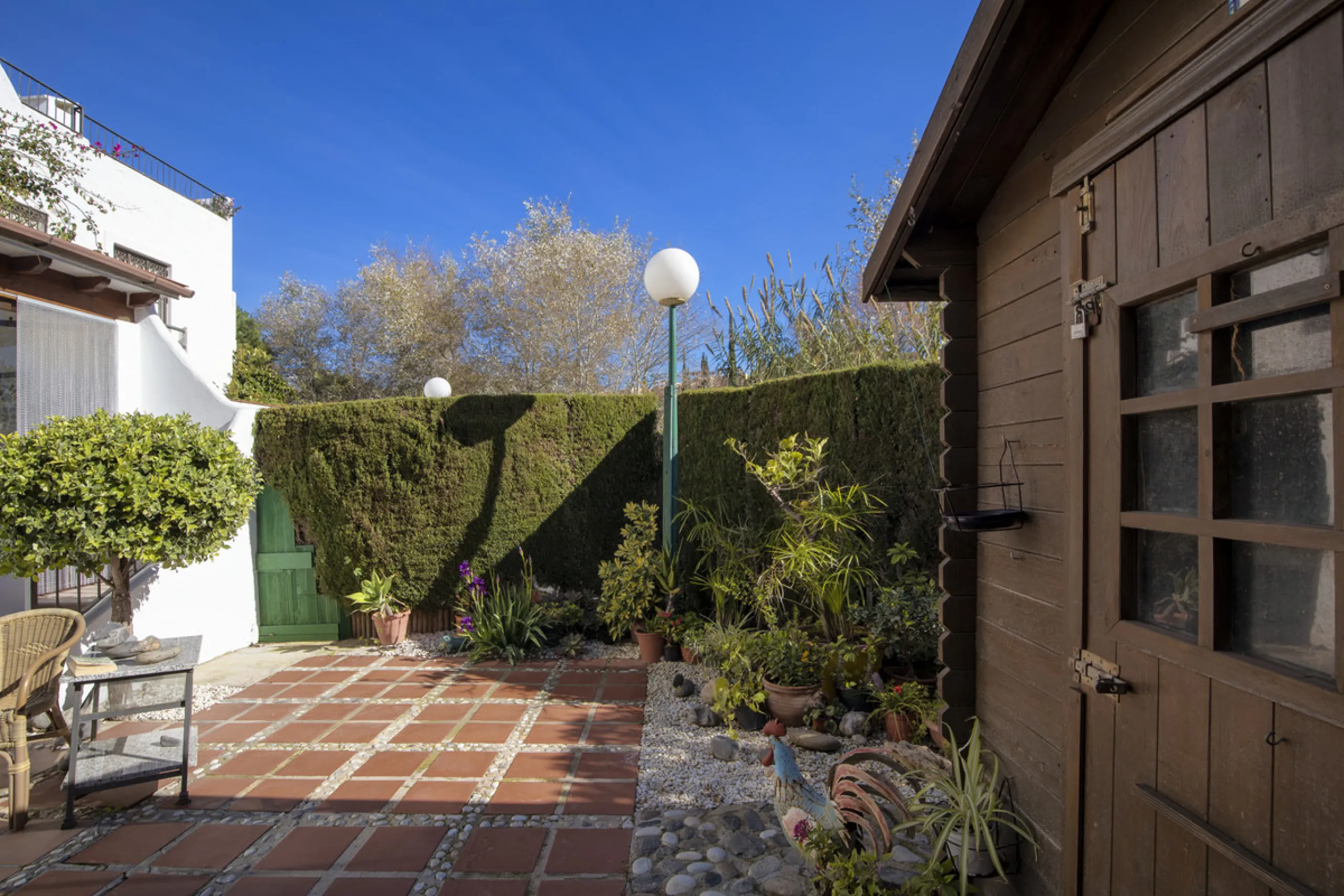 This charming two-level property offers spacious and versatile accommodation, finished to a high standard and filled with natural light throughout. The large living room is a welcoming focal point, featuring marble flooring, a beamed ceiling, a wood-burni