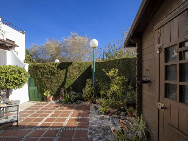 This charming two-level property offers spacious and versatile accommodation, finished to a high standard and filled with natural light throughout. The large living room is a welcoming focal point, featuring marble flooring, a beamed ceiling, a wood-burni