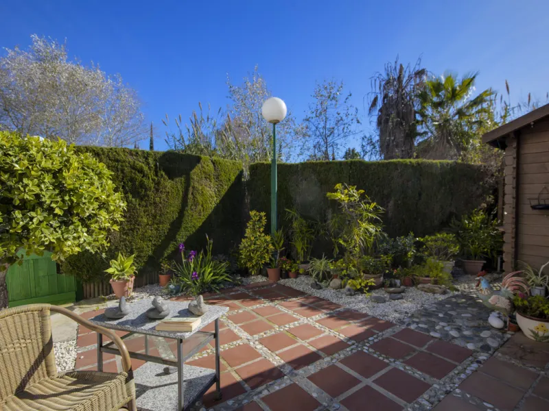 This charming two-level property offers spacious and versatile accommodation, finished to a high standard and filled with natural light throughout. The large living room is a welcoming focal point, featuring marble flooring, a beamed ceiling, a wood-burni