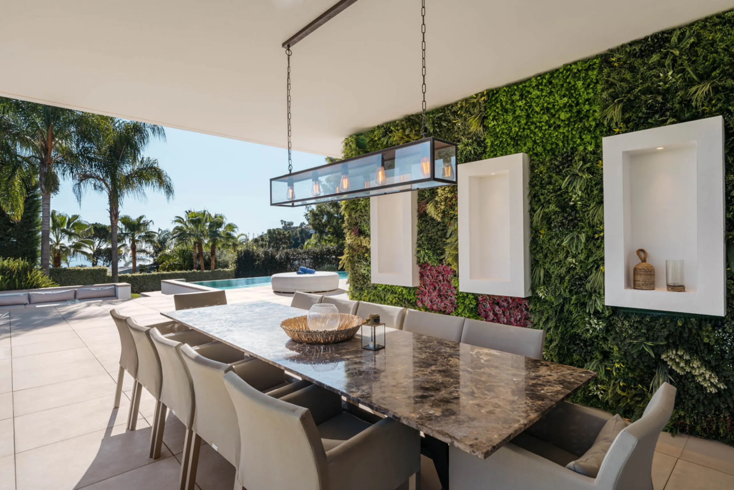 Designed by a distinguished architect, this villa is spread over two levels with an impressive built area. It features five luxurious bedrooms, each with its ensuite bathroom, an additional guest toilet, and a guest apartment that matches the main villa's