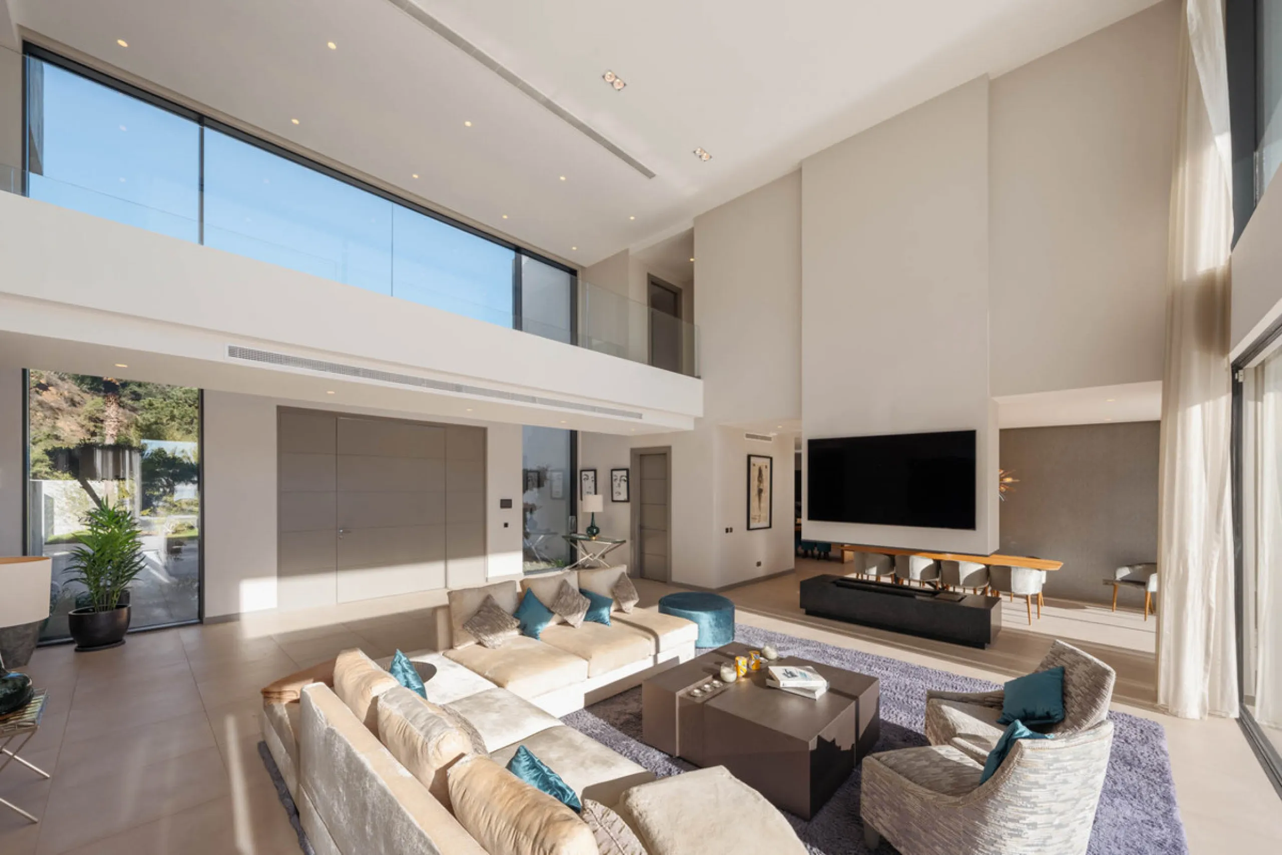 Designed by a distinguished architect, this villa is spread over two levels with an impressive built area. It features five luxurious bedrooms, each with its ensuite bathroom, an additional guest toilet, and a guest apartment that matches the main villa's