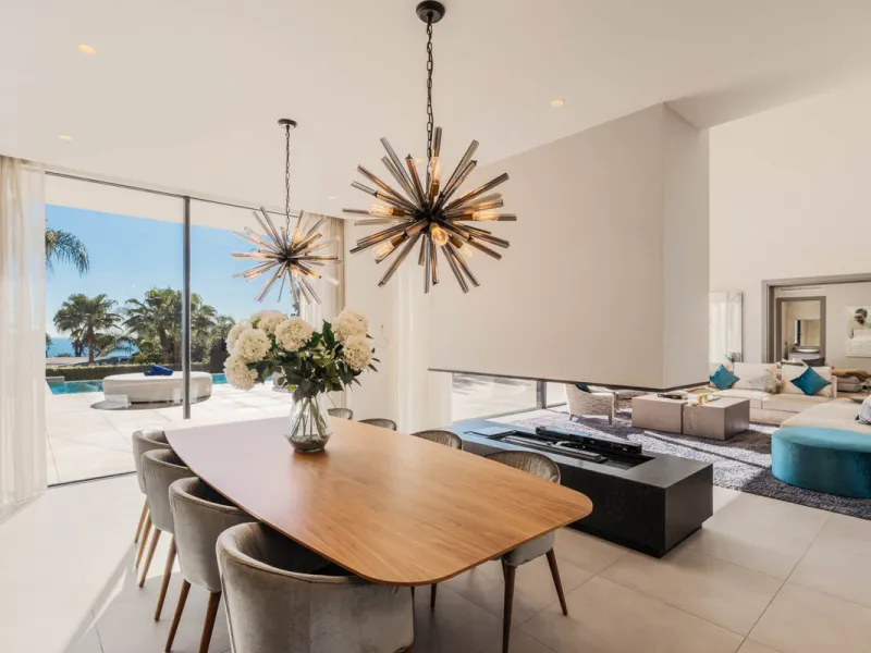 Designed by a distinguished architect, this villa is spread over two levels with an impressive built area. It features five luxurious bedrooms, each with its ensuite bathroom, an additional guest toilet, and a guest apartment that matches the main villa's