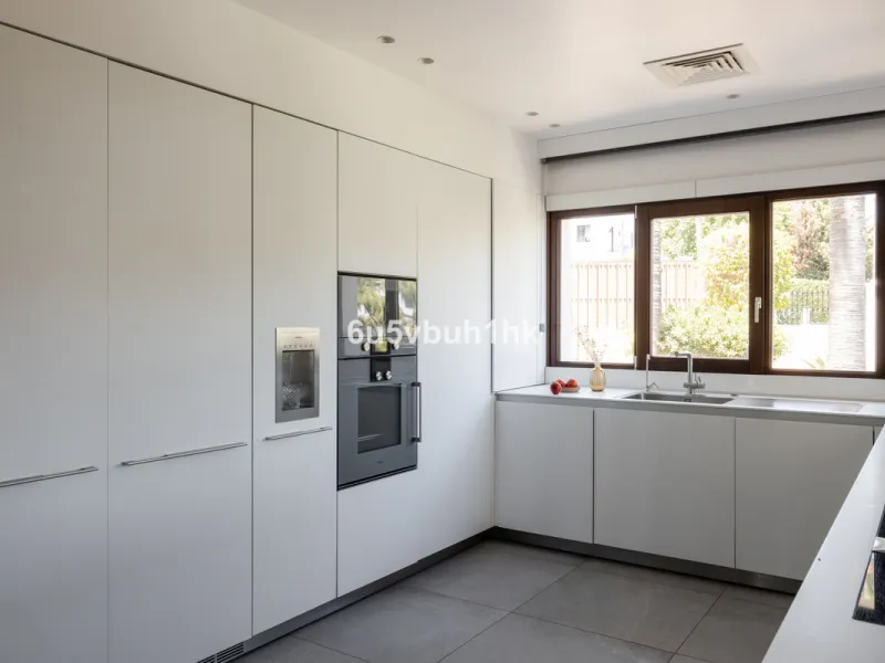 Nestled on a spacious 3,920 square meter plot, this generational Estate boasts a total built area of 842 square meters, spread across four floors with an elevator, located in one of Marbella's prime urbanizations. Surrounded by the lush nature of Las Chap