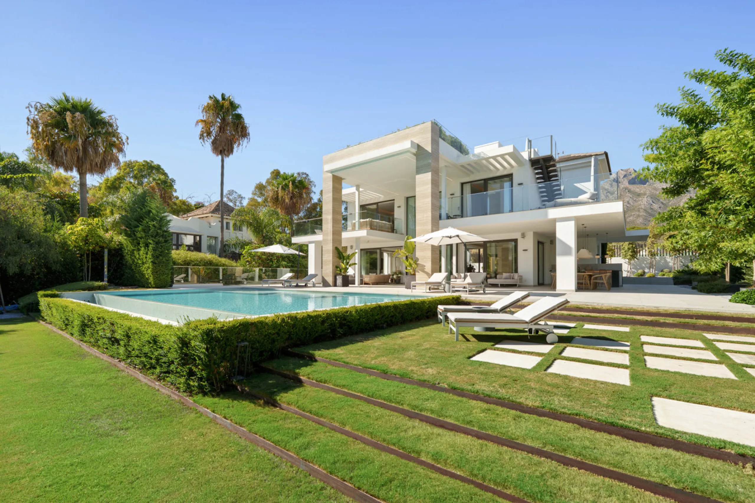Nestled in the prestigious Altos de Puente Romano on Marbella's Golden Mile, Villa Romano is the epitome of modern Mediterranean luxury. This striking six-bedroom, six-bathroom residence blends sleek contemporary architecture with warm natural tones, crea