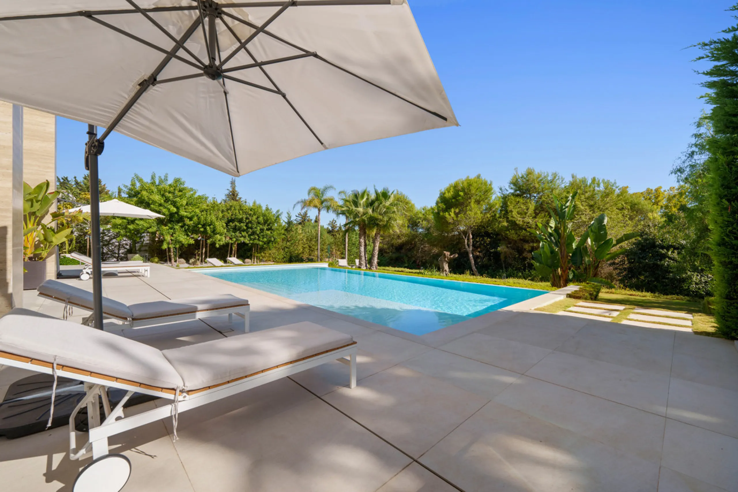 Nestled in the prestigious Altos de Puente Romano on Marbella's Golden Mile, Villa Romano is the epitome of modern Mediterranean luxury. This striking six-bedroom, six-bathroom residence blends sleek contemporary architecture with warm natural tones, crea