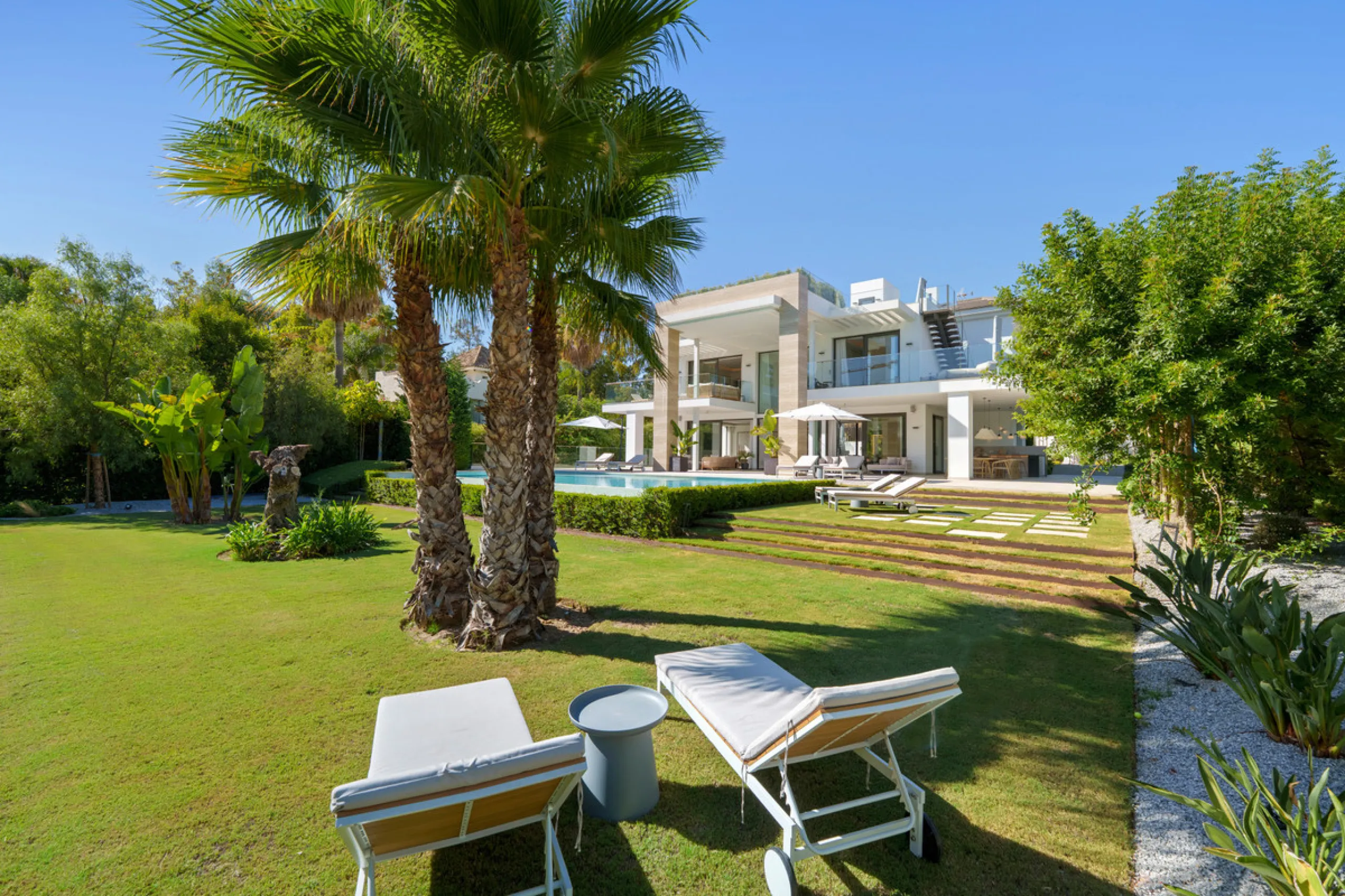 Nestled in the prestigious Altos de Puente Romano on Marbella's Golden Mile, Villa Romano is the epitome of modern Mediterranean luxury. This striking six-bedroom, six-bathroom residence blends sleek contemporary architecture with warm natural tones, crea