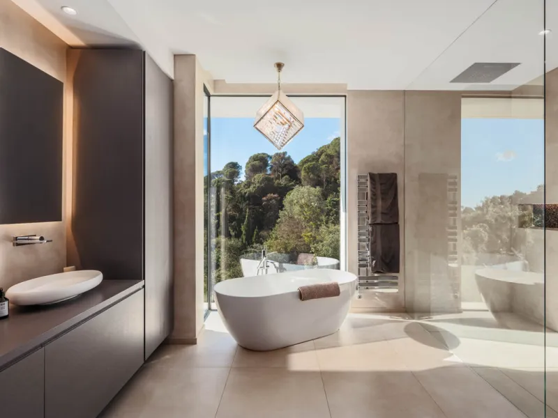 Designed by a distinguished architect, this villa is spread over two levels with an impressive built area. It features five luxurious bedrooms, each with its ensuite bathroom, an additional guest toilet, and a guest apartment that matches the main villa's