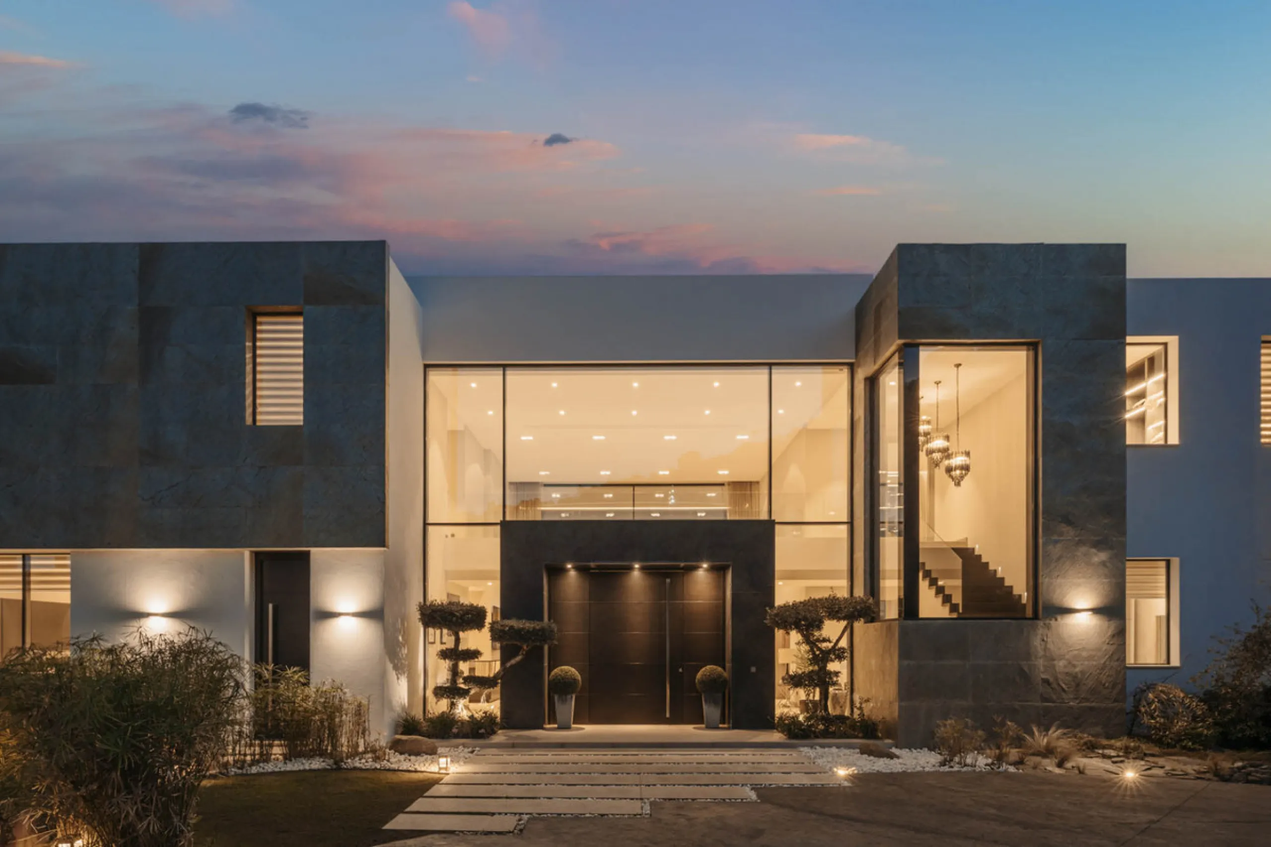 Designed by a distinguished architect, this villa is spread over two levels with an impressive built area. It features five luxurious bedrooms, each with its ensuite bathroom, an additional guest toilet, and a guest apartment that matches the main villa's