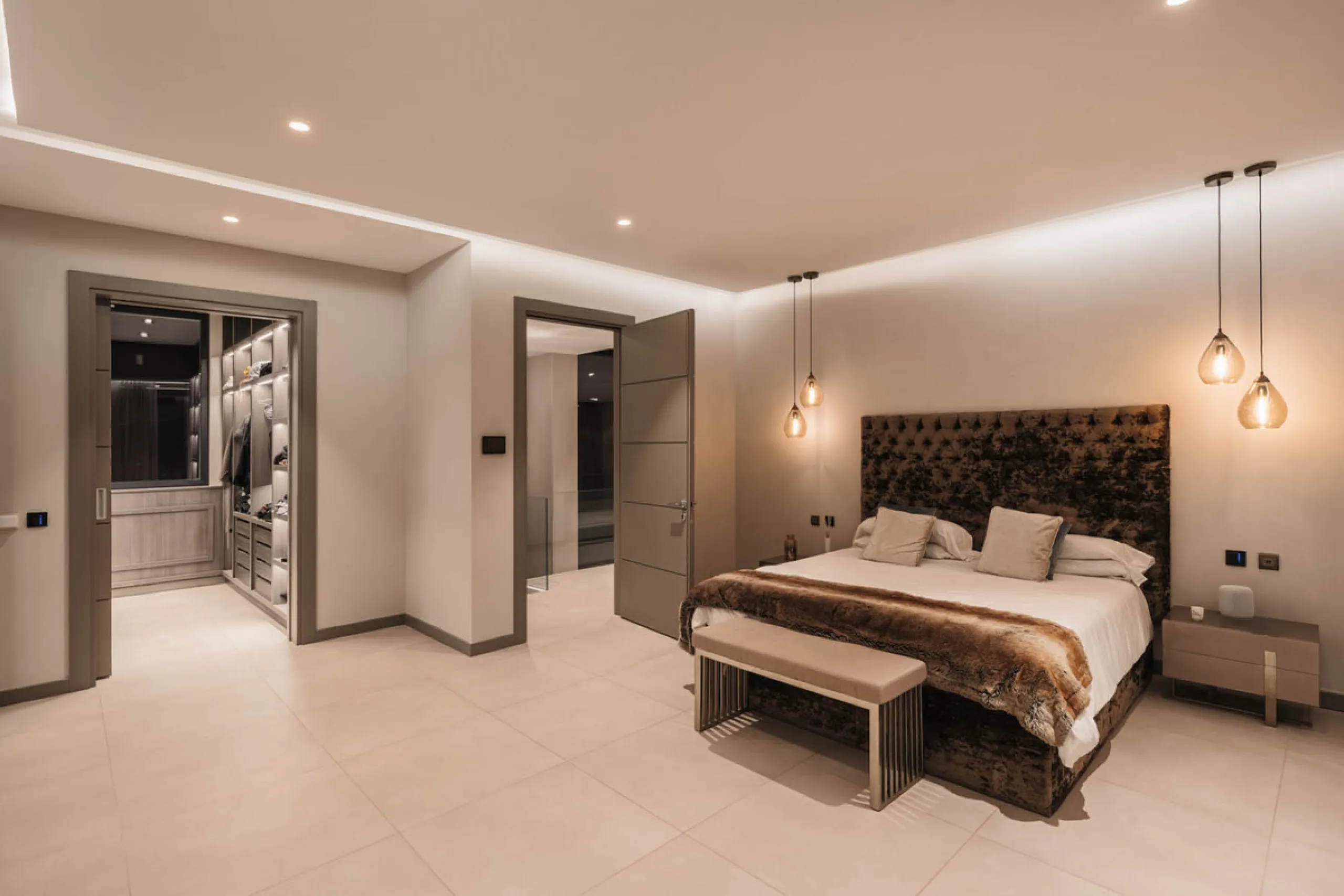Designed by a distinguished architect, this villa is spread over two levels with an impressive built area. It features five luxurious bedrooms, each with its ensuite bathroom, an additional guest toilet, and a guest apartment that matches the main villa's