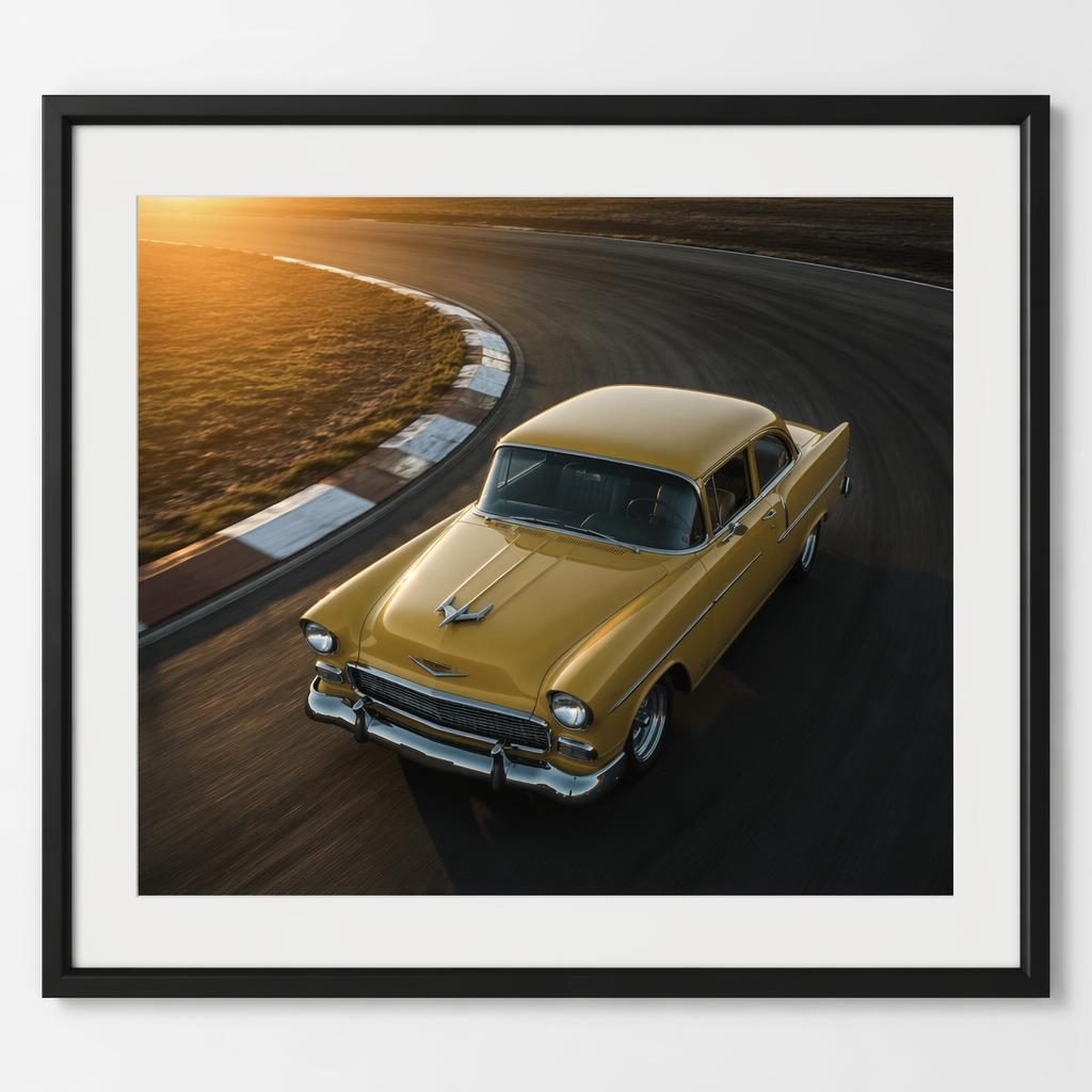 Aerial view of a mustard yellow 1950s American sedan on a race track at dawn, with cinematic lighting and glossy reflections.
